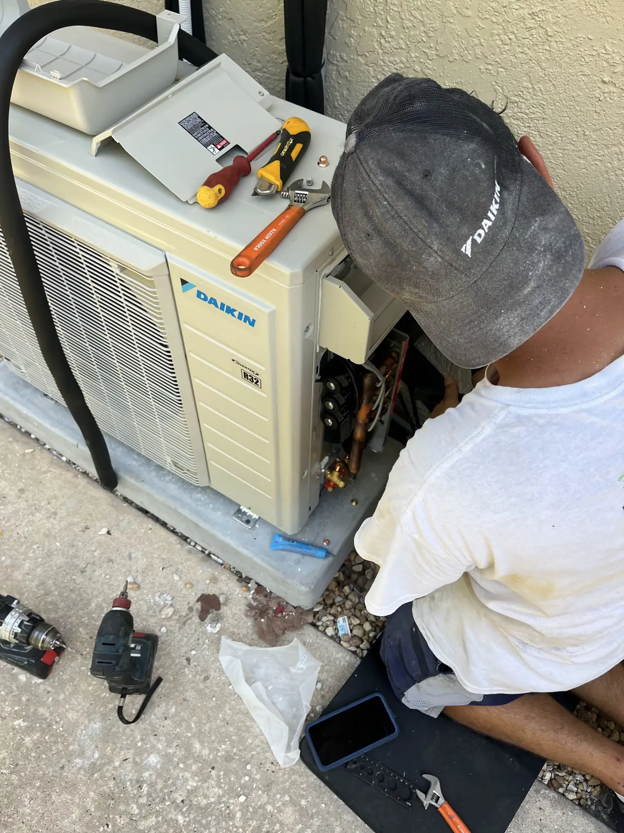 Technician commissioning a new Daikin outdoor unit